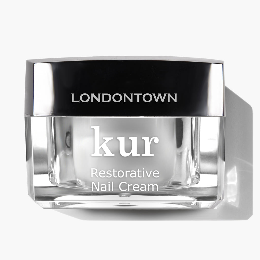 A container of Londontown kur Restorative Nail Cream with a silver lid and clear base on a white background.